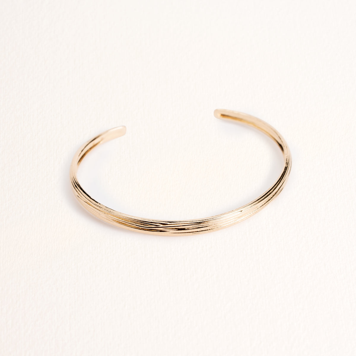 Bracelet jonc Olga doré en plaqué or 18 carats, épais, avec une surface gravée et texturée aux lignes irrégulières