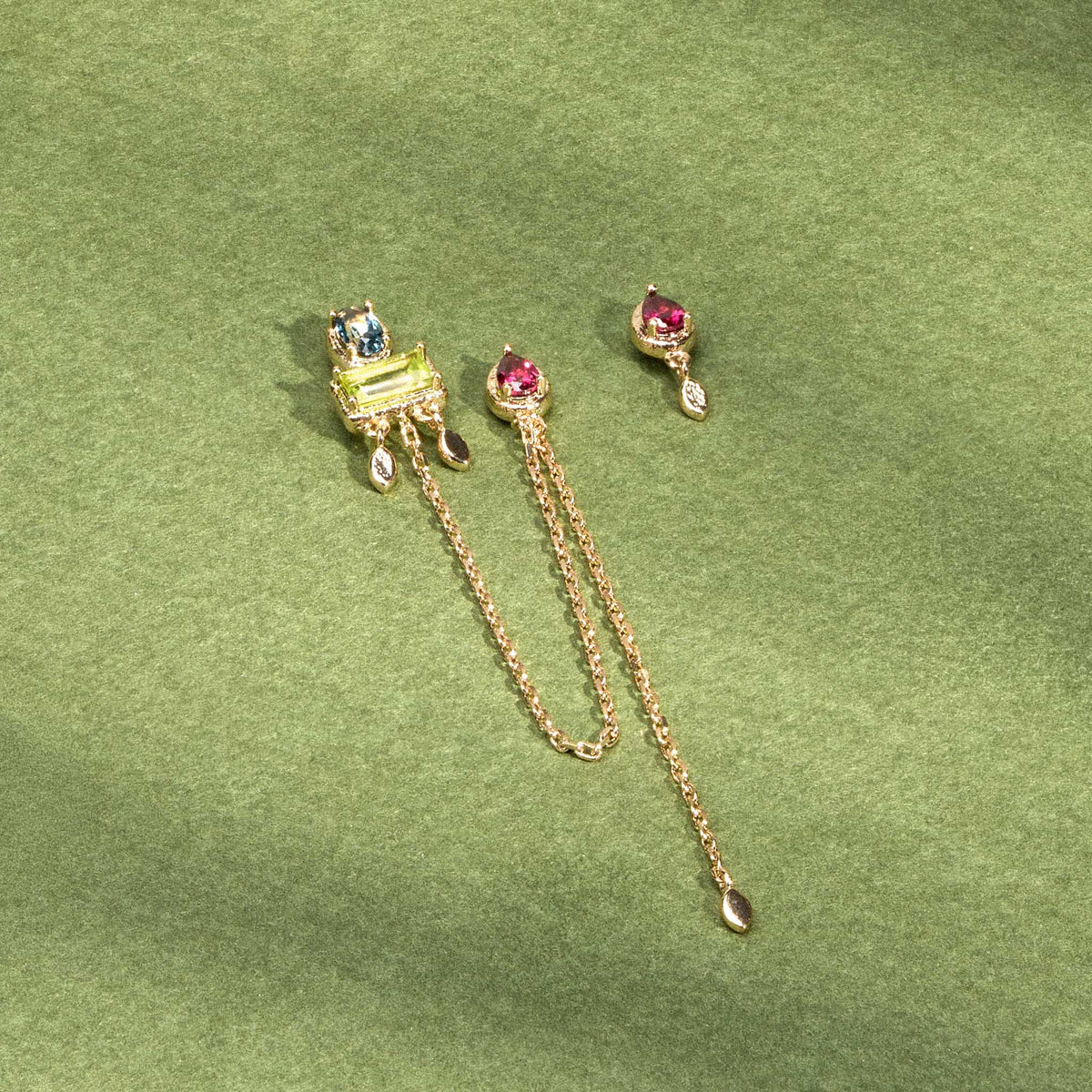 Boucles d’oreilles Sienna dorées en plaqué or 18 carats, avec une boucle longue reliant deux trous ornée de topaze London Blue, rhodolite et péridot et une puce d’oreille ornée d'une rhodolite