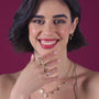 Femme portant la bague Estelle en Plaqué or 75‰ (18 carats), ornée d'un rubis et de péridots.